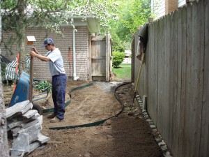 Step 2 of Site Prep, our worker installs a solid base to lay the flagstone walkway on Troy, MI